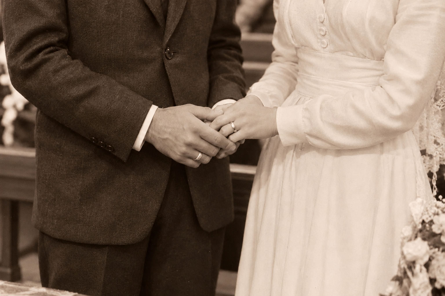 Primo piano degli sposi che si tengono per mano.